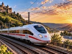 NRW’de demir yolu hattı 30 Ekim’e kadar kapalı: Köln ve Düsseldorf seferleri de etkileniyor Yeşil alanların arasından geçen yolcu trenini gösteren temsili görsel